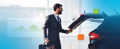 Photo of man opening back hatch of his parked vehicle.