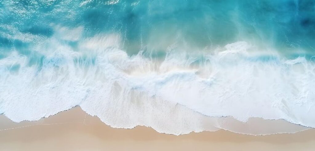 Photo of waves crashing onto beach.